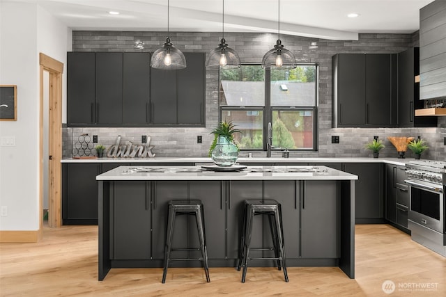 91 Pebble Beach Dr, Cle Elum, WA 98922 - kitchen with high end stainless steel range, a kitchen island, light countertops, tasteful backsplash, and recessed lighting