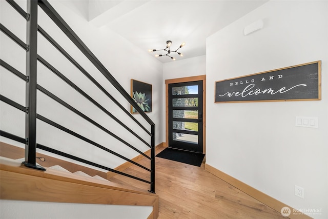 91 Pebble Beach Dr, Cle Elum, WA 98922 - foyer with stairway, wood finished floors, a chandelier, and baseboards