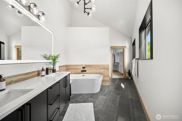 91 Pebble Beach Dr, Cle Elum, WA 98922 - bathroom with a freestanding bath, double vanity, a walk in closet, a chandelier, and high vaulted ceiling