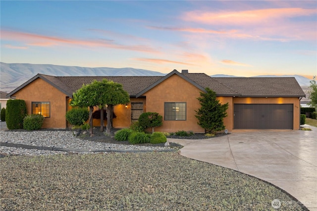 510 Lakeside Way SW, Mattawa, WA 99349 - view of front of home with concrete driveway, an attached garage, stucco siding, and a mountain view