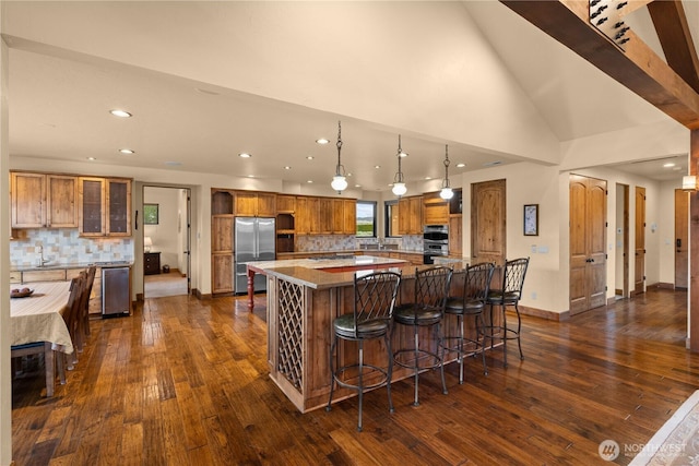 510 Lakeside Way SW, Mattawa, WA 99349 - kitchen featuring appliances with stainless steel finishes, a spacious island, backsplash, brown cabinets, and recessed lighting