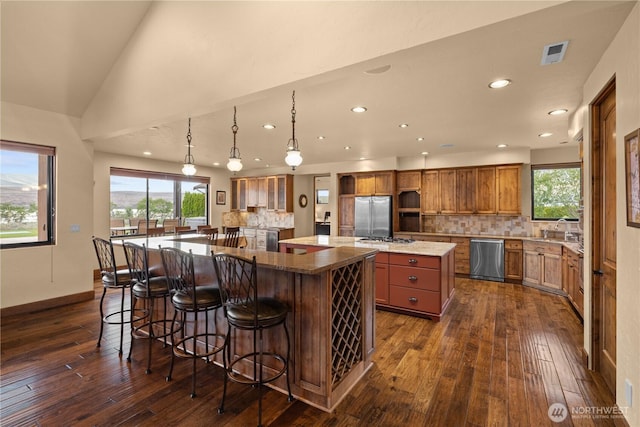 510 Lakeside Way SW, Mattawa, WA 99349 - kitchen with a spacious island, appliances with stainless steel finishes, brown cabinets, dark wood-type flooring, and recessed lighting