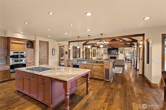510 Lakeside Way SW, Mattawa, WA 99349 - kitchen featuring a kitchen island, appliances with stainless steel finishes, open floor plan, open shelves, and a kitchen bar