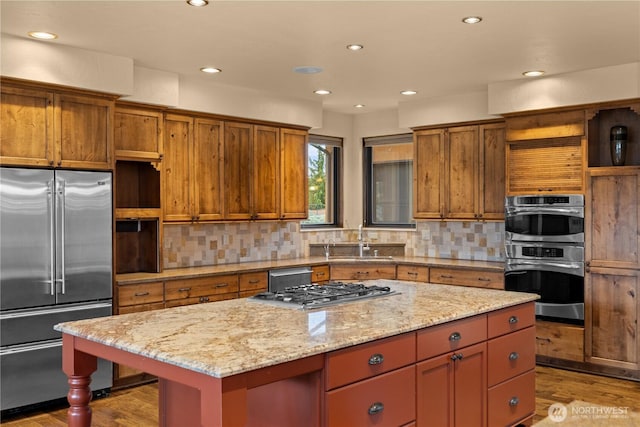 510 Lakeside Way SW, Mattawa, WA 99349 - kitchen featuring appliances with stainless steel finishes, open shelves, a sink, light wood-type flooring, and a center island