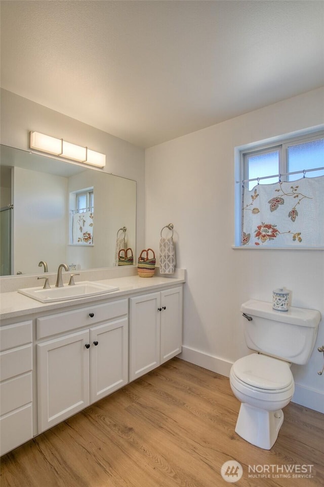 1472 Storm King Ave SW Unit A, Ocean Shores, WA 98569 - bathroom with toilet, vanity, wood finished floors, and baseboards