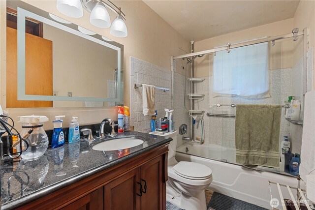 9712 126th St E, Puyallup, WA 98373 - bathroom with vanity, toilet, and enclosed tub / shower combo