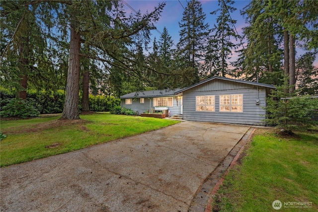 9712 126th St E, Puyallup, WA 98373 - view of front of home featuring concrete driveway and a yard