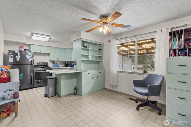 9712 126th St E, Puyallup, WA 98373 - kitchen with appliances with stainless steel finishes, green cabinetry, a peninsula, ceiling fan, and light countertops