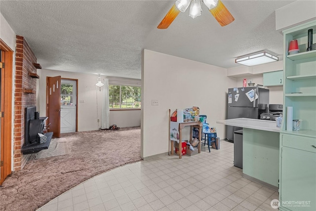 9712 126th St E, Puyallup, WA 98373 - kitchen with open shelves, a textured ceiling, a wood stove, a ceiling fan, and green cabinets