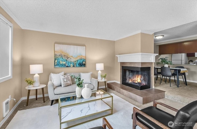 13013 E Gibson Rd Unit M223, Everett, WA 98204 - carpeted living room featuring a tile fireplace, ornamental molding, a textured ceiling, and baseboards