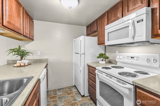 13013 E Gibson Rd Unit M223, Everett, WA 98204 - kitchen with white appliances, stone finish floors, a sink, light countertops, and brown cabinets