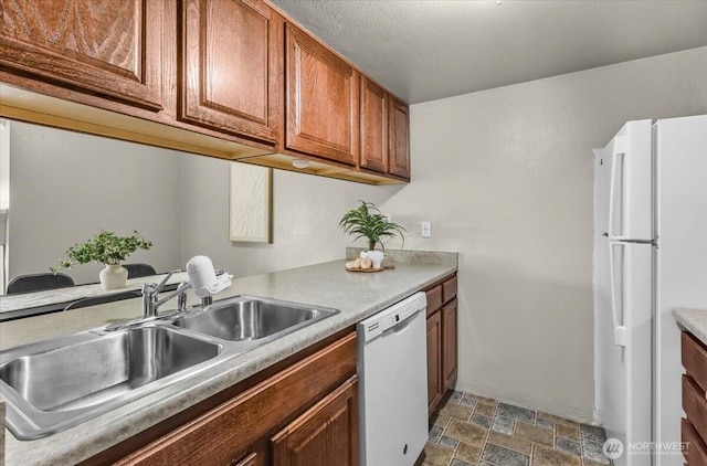 13013 E Gibson Rd Unit M223, Everett, WA 98204 - kitchen with white appliances, stone finish flooring, a sink, brown cabinets, and light countertops