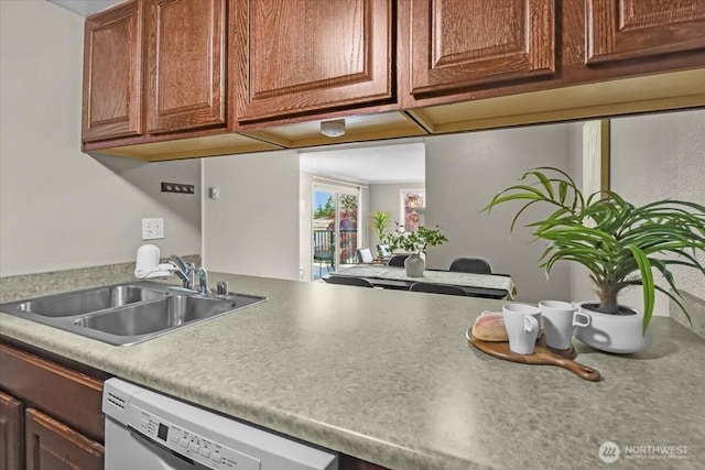 13013 E Gibson Rd Unit M223, Everett, WA 98204 - kitchen with dishwasher, a sink, light countertops, and brown cabinets