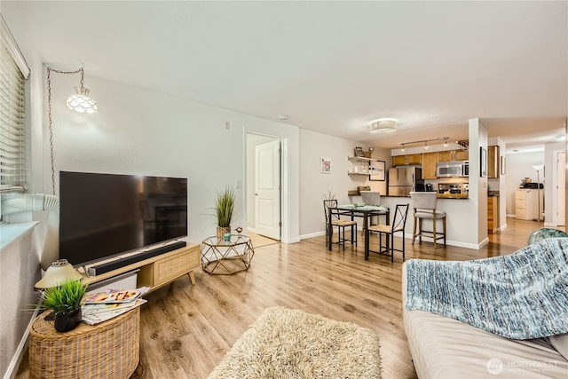3045 20th Ave W Unit 108, Seattle, WA 98199 - living area featuring light wood-style flooring and baseboards