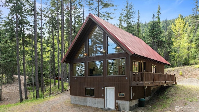 760 Rodeo Rd, Cle Elum, WA 98922 - view of property exterior featuring a forest view, metal roof, and a wooden deck