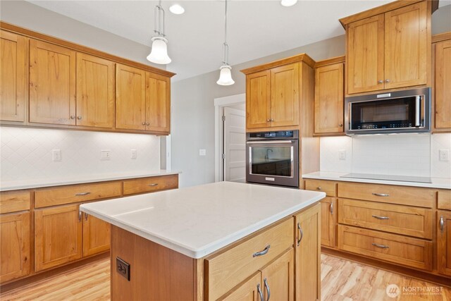 15 Cabana Dr, Silverlake, WA 98645 - kitchen with appliances with stainless steel finishes, light wood-type flooring, tasteful backsplash, light countertops, and recessed lighting