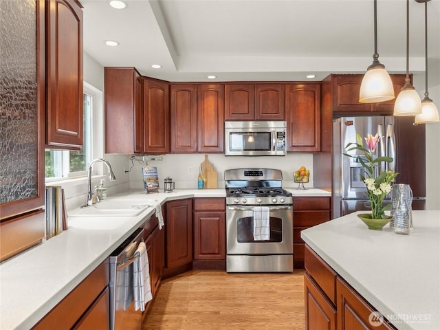 8609 E Caraway Rd, Port Orchard, WA 98366 - kitchen featuring stainless steel appliances, recessed lighting, light wood-style floors, decorative light fixtures, and light countertops