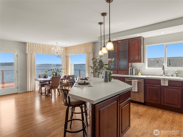 8609 E Caraway Rd, Port Orchard, WA 98366 - kitchen featuring stainless steel dishwasher, a chandelier, light countertops, a center island, and a sink