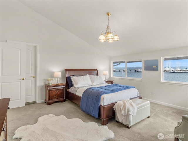 8609 E Caraway Rd, Port Orchard, WA 98366 - carpeted bedroom with a chandelier, vaulted ceiling, baseboards, and a water view