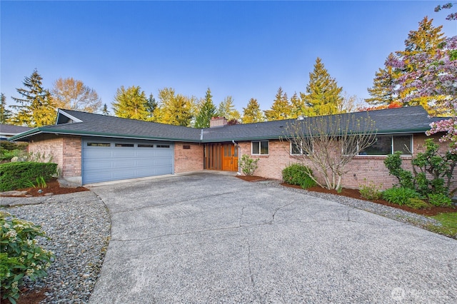 1323 121st Ave SE, Bellevue, WA 98005 - ranch-style house with a garage, brick siding, concrete driveway, and a chimney