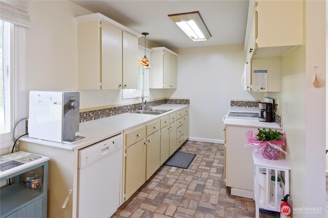 2018 S 253rd St, Des Moines, WA 98198 - kitchen featuring dishwasher, a sink, light countertops, brick patterned flooring, and healthy amount of natural light