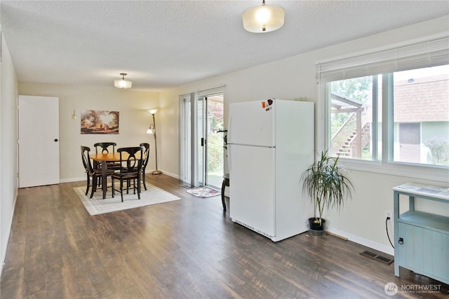 2018 S 253rd St, Des Moines, WA 98198 - dining space featuring plenty of natural light, dark wood-style flooring, a textured ceiling, and baseboards