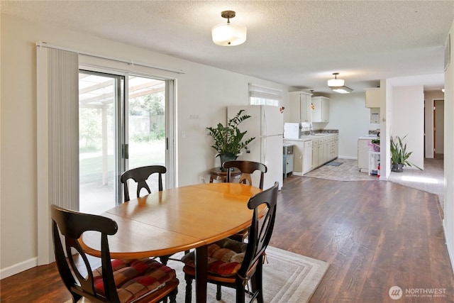 2018 S 253rd St, Des Moines, WA 98198 - dining room featuring wood finished floors, plenty of natural light, a textured ceiling, and baseboards