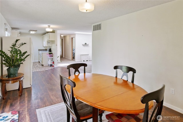 2018 S 253rd St, Des Moines, WA 98198 - dining area featuring wood finished floors, baseboards, and a textured ceiling
