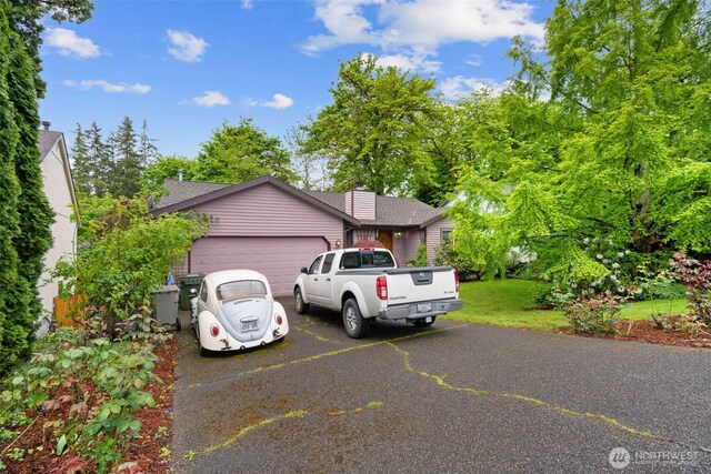26603 199th Pl SE, Covington, WA 98042 - view of front of home featuring an attached garage, driveway, roof with shingles, and a chimney