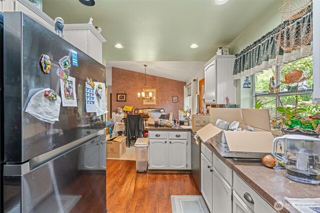 26603 199th Pl SE, Covington, WA 98042 - kitchen with appliances with stainless steel finishes, dark wood finished floors, a chandelier, white cabinets, and vaulted ceiling