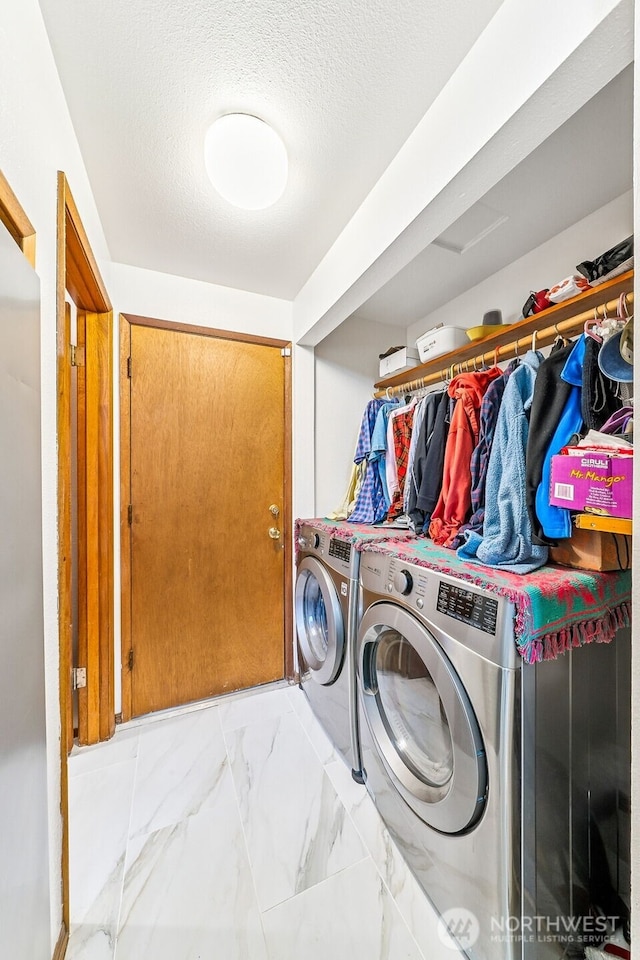 38205 183rd Ave SE, Auburn, WA 98092 - laundry area featuring washer and clothes dryer, marble finish floors, and a textured ceiling