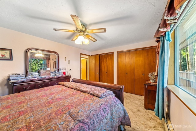 38205 183rd Ave SE, Auburn, WA 98092 - bedroom featuring light carpet, two closets, and ceiling fan