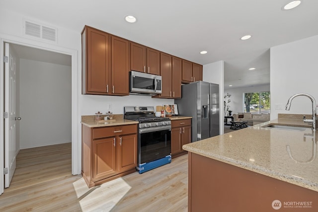 3905 S 337th St, Federal Way, WA 98001 - kitchen featuring stainless steel appliances, a sink, light wood-type flooring, light stone countertops, and recessed lighting
