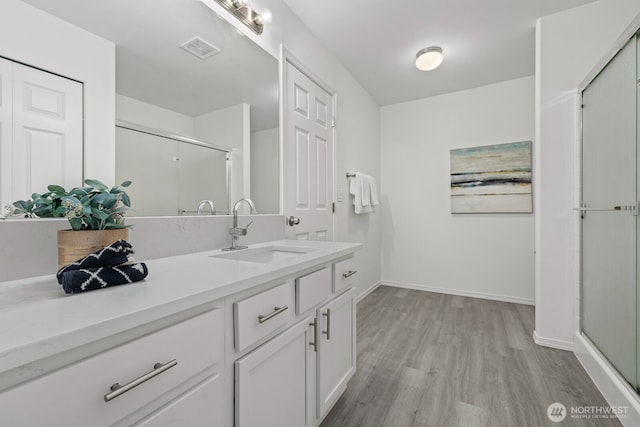 3905 S 337th St, Federal Way, WA 98001 - bathroom with vanity, wood finished floors, baseboards, and a shower stall