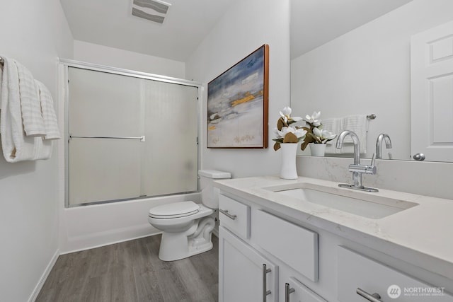 3905 S 337th St, Federal Way, WA 98001 - full bath featuring vanity, wood finished floors, toilet, and bath / shower combo with glass door