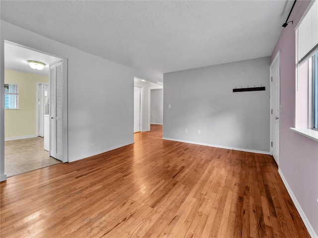 14746 26th Ave NE, Shoreline, WA 98155 - unfurnished room featuring light wood-style floors and baseboards