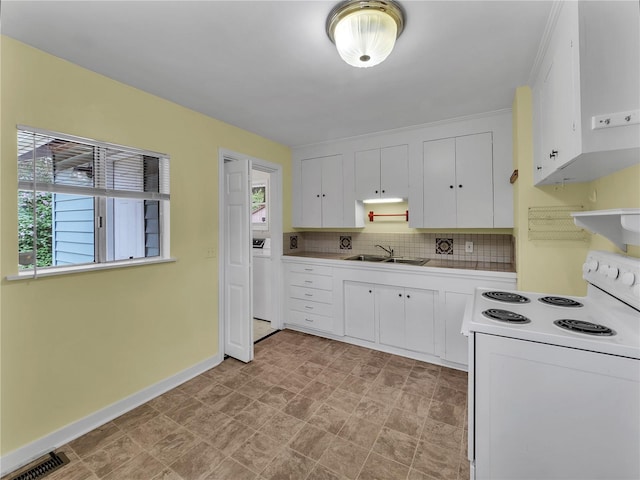 14746 26th Ave NE, Shoreline, WA 98155 - kitchen featuring white range with electric stovetop, plenty of natural light, white cabinets, and decorative backsplash