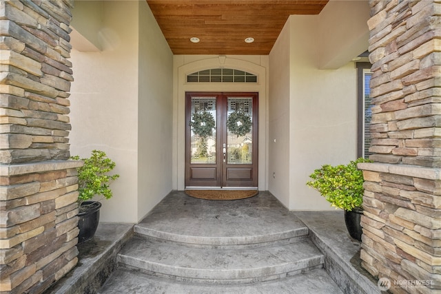 15002 147th Ave E, Orting, WA 98360 - view of exterior entry with french doors, stucco siding, and stone siding