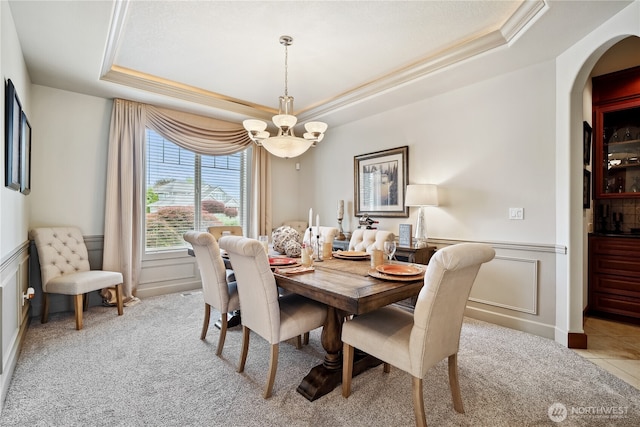 15002 147th Ave E, Orting, WA 98360 - dining area with a tray ceiling, a chandelier, crown molding, arched walkways, and carpet