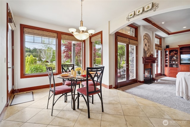15002 147th Ave E, Orting, WA 98360 - dining area featuring a chandelier, light tile patterned floors, baseboards, and a glass covered fireplace