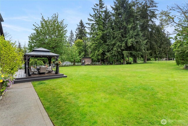 29122 71st Ave E, Graham, WA 98338 - view of grassy yard with a gazebo, a wooden deck, and view of wooded area