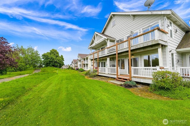 262 W Maberry Dr Unit 102, Lynden, WA 98264 - rear view of house featuring a balcony and a lawn