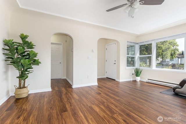 811 E 60th St, Tacoma, WA 98404 - unfurnished living room featuring a baseboard heating unit, arched walkways, a ceiling fan, wood finished floors, and baseboards