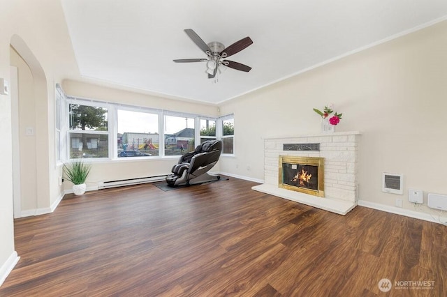 811 E 60th St, Tacoma, WA 98404 - workout room featuring arched walkways, a brick fireplace, and wood finished floors