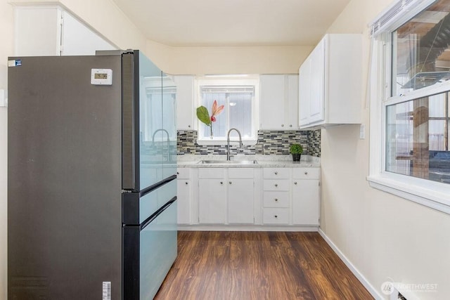 811 E 60th St, Tacoma, WA 98404 - kitchen with freestanding refrigerator, a sink, light countertops, dark wood finished floors, and decorative backsplash