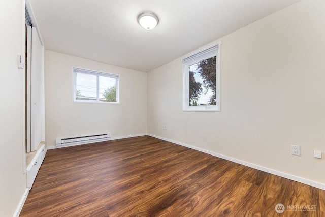 811 E 60th St, Tacoma, WA 98404 - unfurnished bedroom with a baseboard heating unit, wood finished floors, baseboards, and a closet