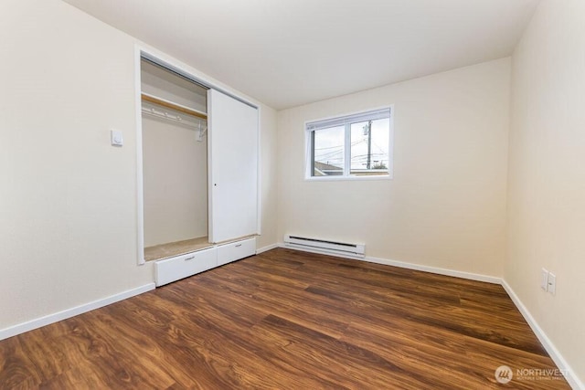 811 E 60th St, Tacoma, WA 98404 - unfurnished bedroom featuring a baseboard radiator, dark wood finished floors, baseboards, and a closet