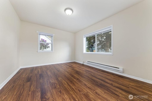 811 E 60th St, Tacoma, WA 98404 - spare room with a baseboard heating unit, dark wood-style flooring, and baseboards