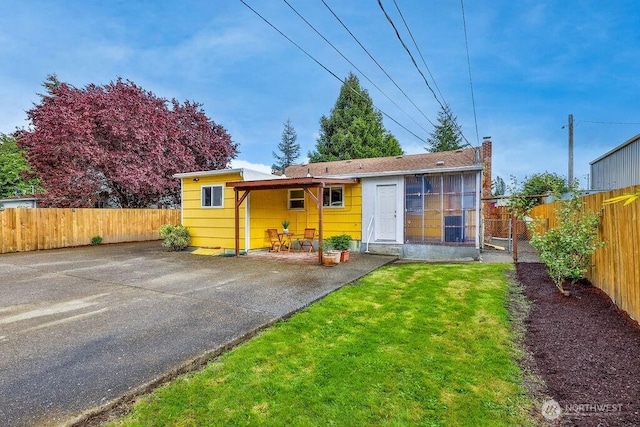 811 E 60th St, Tacoma, WA 98404 - view of front of house with a patio area and a chimney