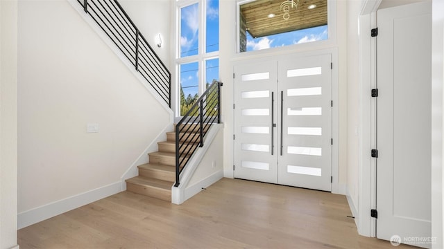 17109 NE 16th Pl, Bellevue, WA 98008 - entryway featuring light wood finished floors, baseboards, stairs, plenty of natural light, and a towering ceiling